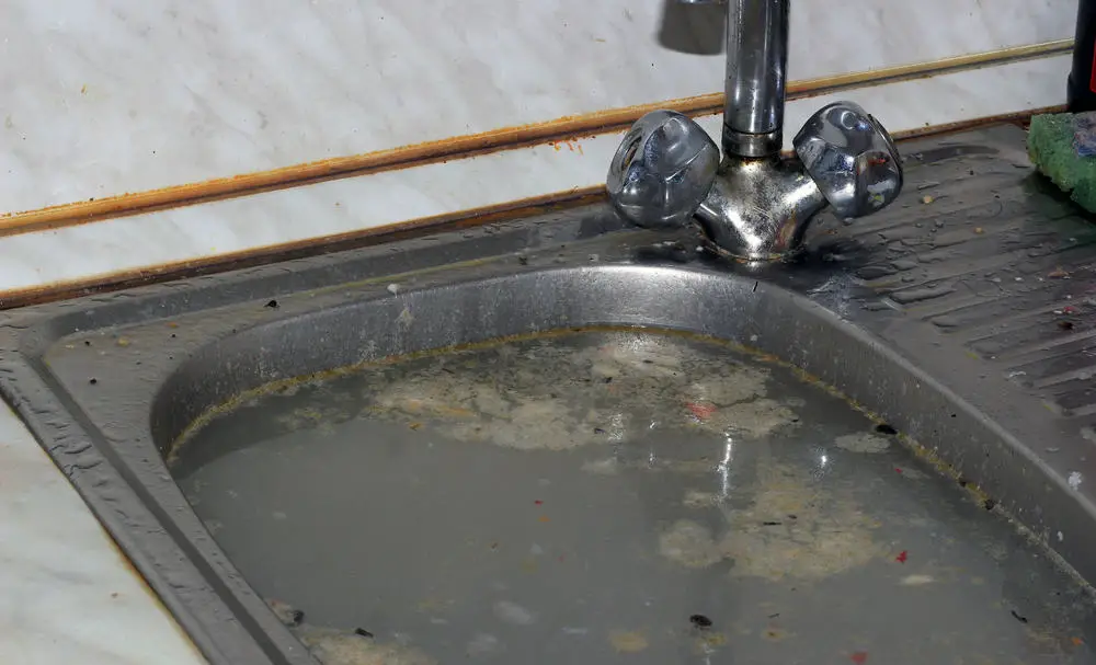 clog in driain between bathroom tub and kitchen sink