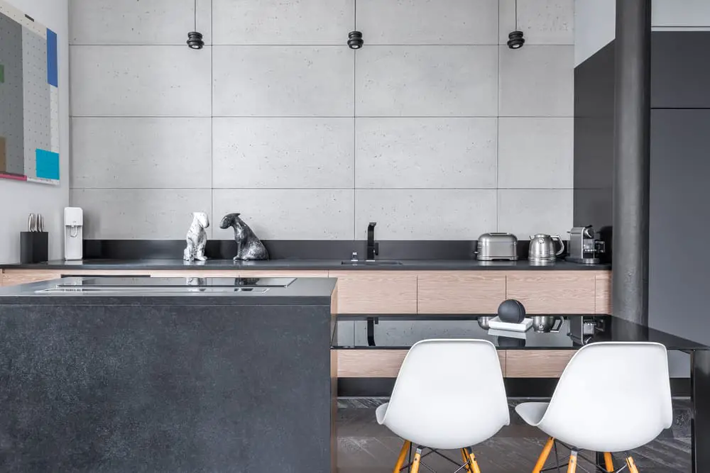 modern kitchen with black table and white chairs