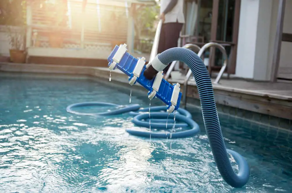 cleaning a pool with a vacuum tube cleaner